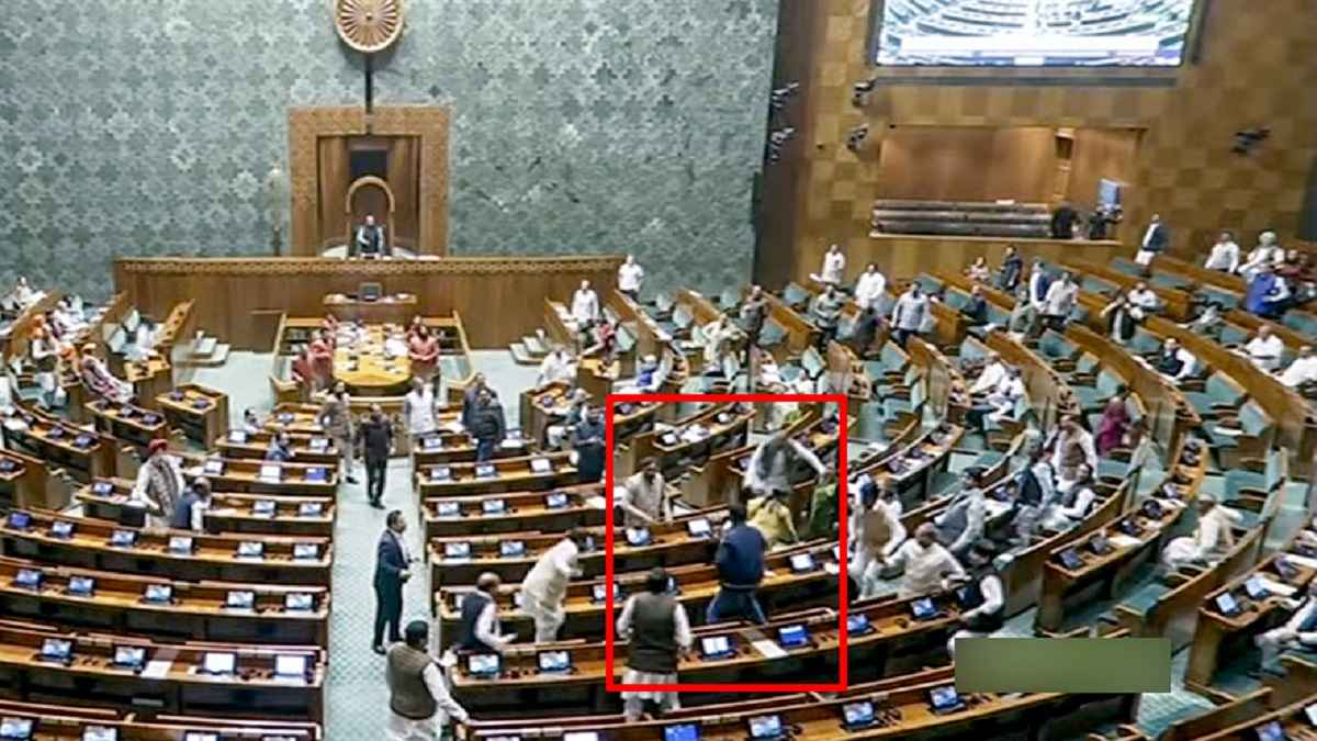 A video grab shows an unidentified man jumping from the visitor's gallery of Lok Sabha