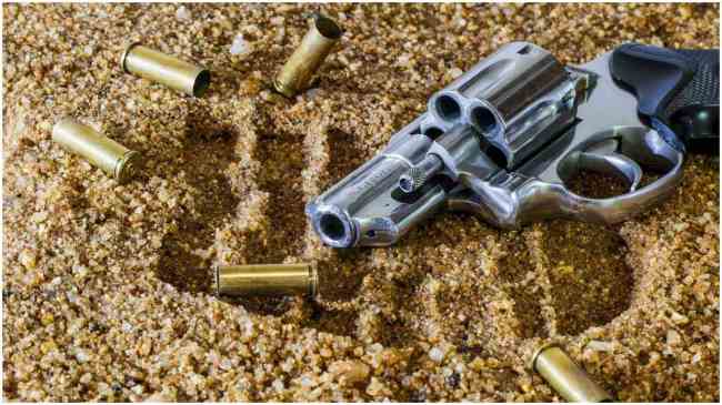 gun and bullets lying on the ground