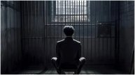 Man Sitting In Prison