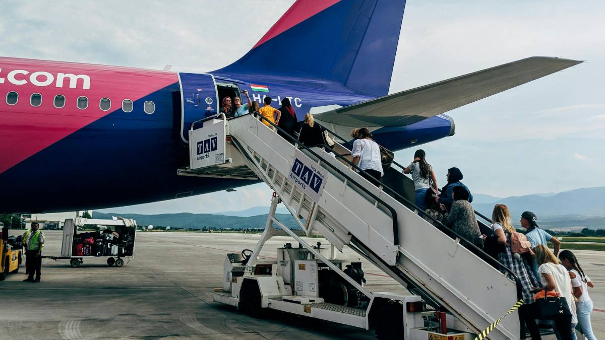 Travellers Boarding On Plane