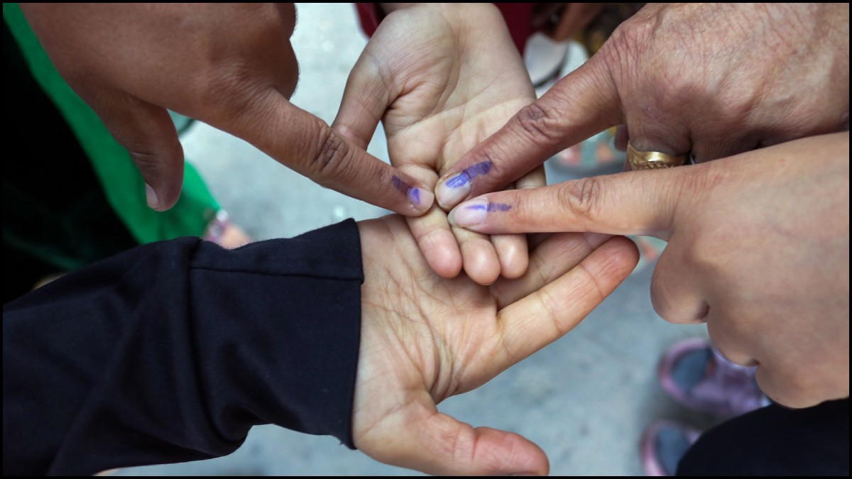 Voters show their ink-marked fingers after casting their vote for the first phase of the Jammu and K