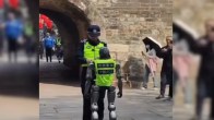 Humanoid robots, wearing high-visibility police vests