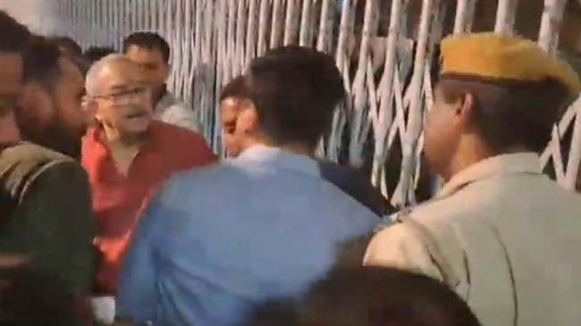 People scuffle with collector